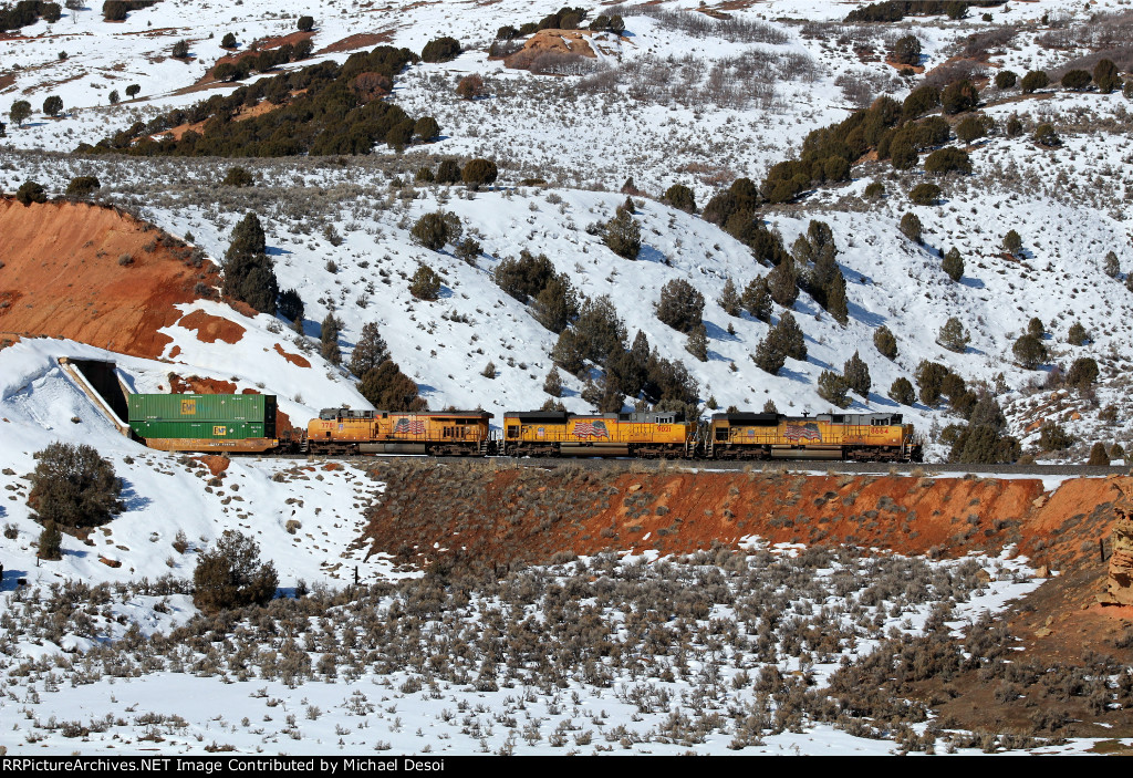 UP 8664, 9021, 7781 (SD70ACE, SD70ACE, C45ACCTE) lead an eastbound stack train, exiting a small tunnel at Castle Rock, Utah. February 19, 2022 {Winter Echofest}